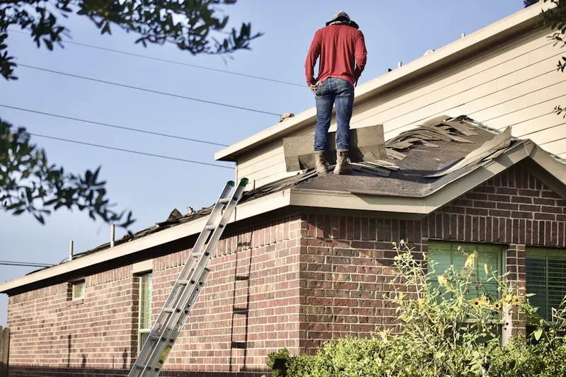 Professional roofer working on a residential roof in Hibernia